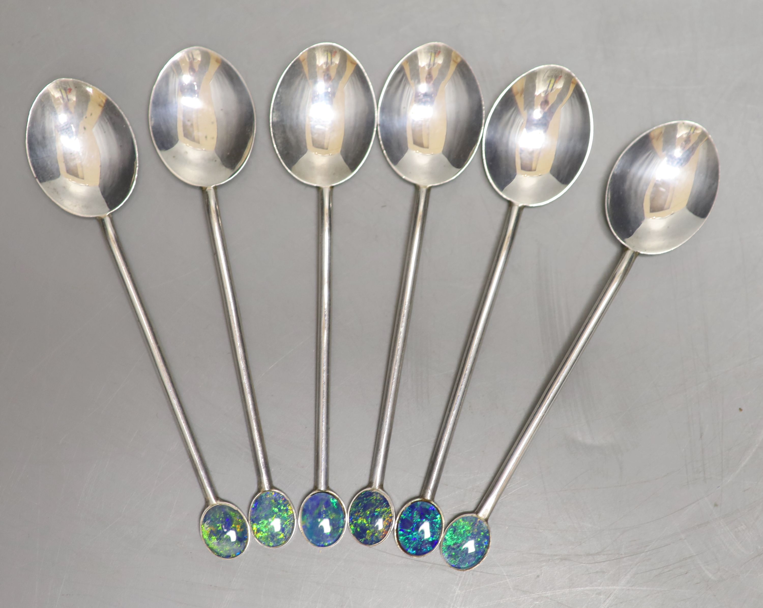 A set of six sterling coffee spoons with faux black opal set terminals, 92mm, gross weight 43 grams.